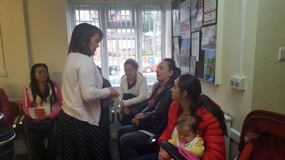 Woman standing talking to a group of women